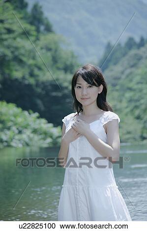 A young woman standing in river View Large Photo Image Stock Image - A young woman standing in river. Fotosearch