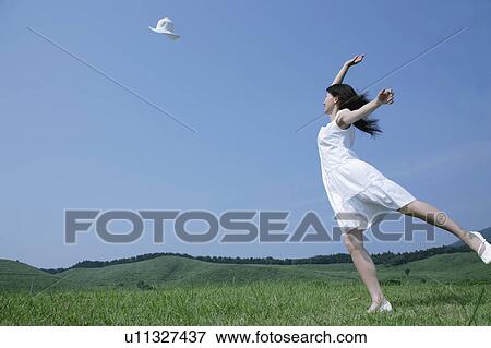 A young woman throwing a hat View Large Photo Image Stock Photo - A young woman throwing a hat. Fotosearch