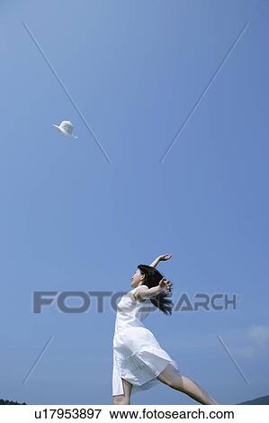 A young woman throwing a hat View Large Photo Image Stock Photo - A young woman throwing a hat. Fotosearch