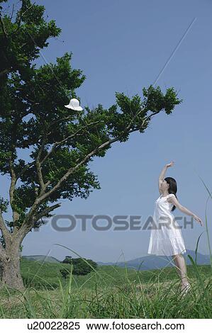 A young woman throwing a hat View Large Photo Image Stock Photography - A young woman throwing a hat. Fotosearch