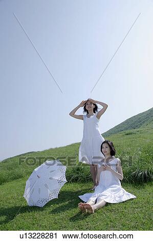 Two young women looking at view View Large Photo Image Stock Image - Two young women looking at view. Fotosearch
