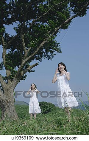 Two young women shouting View Large Photo Image Stock Photo - Two young women shouting. Fotosearch
