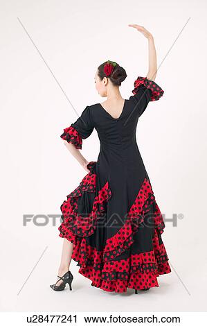 Stock Image - Young woman dancing the flamenco. Fotosearch