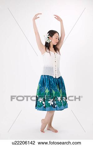 Stock Image - Young woman dancing the hula. Fotosearch