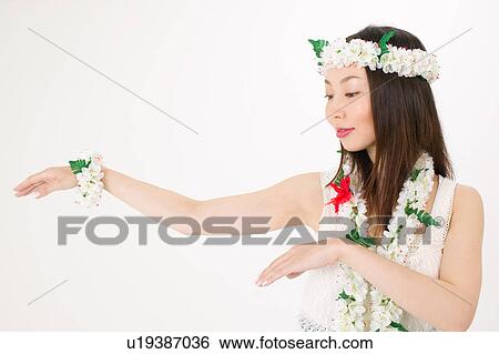 Young woman dancing the hula View Large Photo Image Stock Photograph - Young woman dancing the hula. Fotosearch