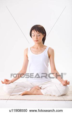 Stock Image - Young woman meditating. Fotosearch