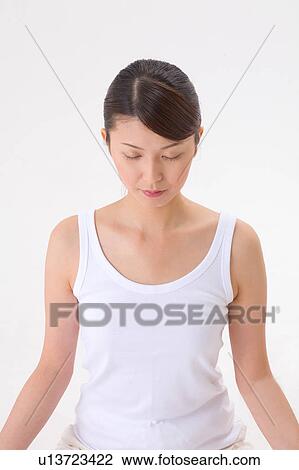 Young woman meditating View Large Photo Image Stock Image - Young woman meditating. Fotosearch