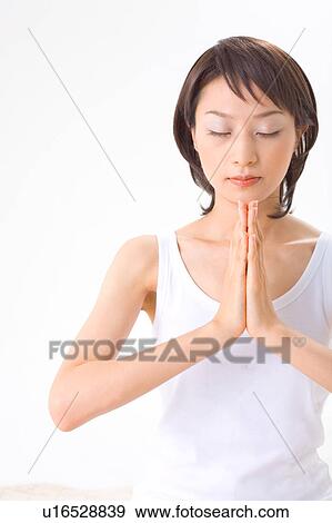 Stock Photo - Young woman meditating. Fotosearch