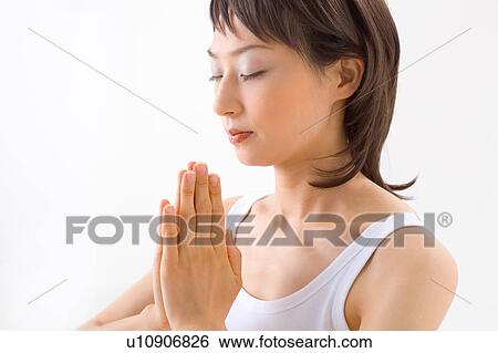Stock Photograph - Young woman meditating. Fotosearch