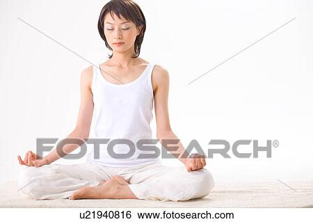 Young woman meditating View Large Photo Image Stock Photograph - Young woman meditating. Fotosearch