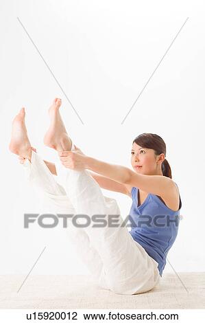 Stock Image - Young woman practicing Pilates. Fotosearch