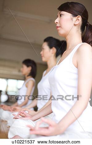 Young women doing Yoga View Large Photo Image Stock Photo - Young women doing Yoga. Fotosearch