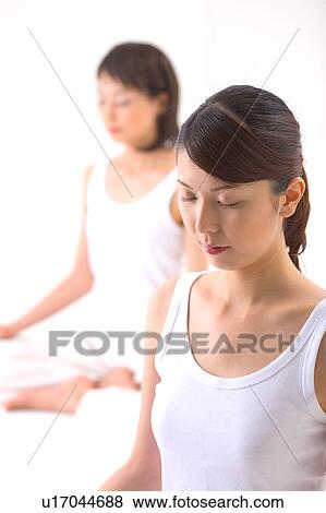 Young women meditating View Large Photo Image Stock Photo - Young women meditating. Fotosearch