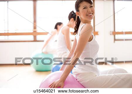 Young women sitting on fitness balls View Large Photo Image Stock Image - Young women sitting on fitness balls. Fotosearch