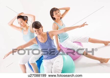Young women sitting on fitness balls View Large Photo Image Stock Photo - Young women sitting on fitness balls. Fotosearch