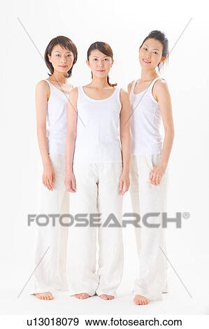 Young women standing side by side View Large Photo Image Stock Photo - Young women standing side by side. Fotosearch