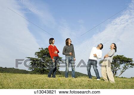 Four young people laughing View Large Photo Image Stock Image - Four young people laughing. Fotosearch