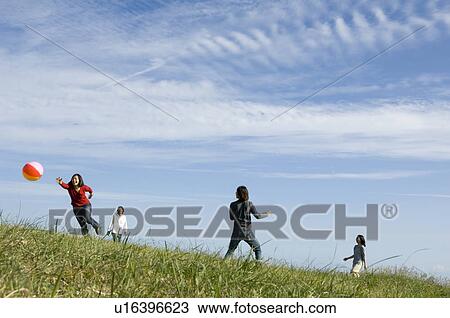 Four young people playing with beach ball View Large Photo Image Stock Image - Four young people playing with beach ball. Fotosearch