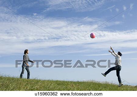 Two young men playing with beach ball View Large Photo Image Stock Image - Two young men playing with beach ball. Fotosearch