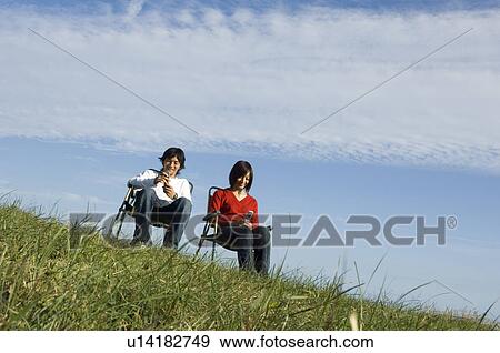 Young couple using mobile phones View Large Photo Image Stock Photo - Young couple using mobile phones. Fotosearch