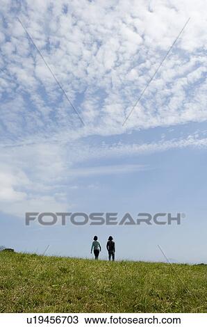 Young couple walking, rear view View Large Photo Image Stock Image - Young couple walking, rear view. Fotosearch