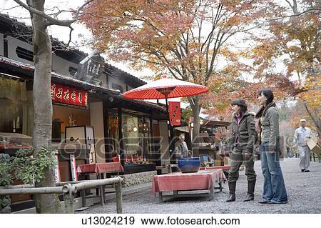 Stock Photo - Two young women browsing at souvenir shop, Ohara Sanzenin Temple, Kyoto Prefecture, Japan. Fotosearch