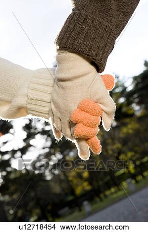 Picture - Two young women holding hands. Fotosearch