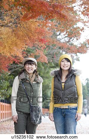 Two young women standing, Kamigamo Shrine, Kyoto Prefecture, Japan View Large Photo Image Stock Image - Two young women standing, Kamigamo Shrine, Kyoto Prefecture, Japan. Fotosearch