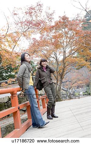 Two young women standing on bridge at Ohara Sanzenin Temple, Kyoto Prefecture, Japan View Large Photo Image Stock Image - Two young women standing on bridge at Ohara Sanzenin Temple, Kyoto Prefecture, Japan. Fotosearch