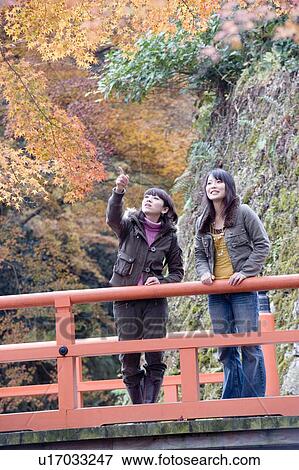 Two young women standing on bridge at Ohara Sanzenin Temple, Kyoto Prefecture, Japan View Large Photo Image Stock Photo - Two young women standing on bridge at Ohara Sanzenin Temple, Kyoto Prefecture, Japan. Fotosearch