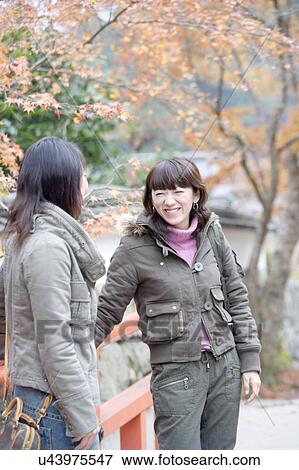Two young women standing on bridge at Ohara Sanzenin Temple, Kyoto Prefecture, Japan View Large Photo Image Stock Photo - Two young women standing on bridge at Ohara Sanzenin Temple, Kyoto Prefecture, Japan. Fotosearch