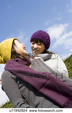 Two young women talking View Large Photo Image Picture - Two young women talking. Fotosearch