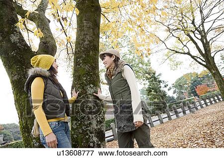 Two young women talking under tree, Kamigamo Shrine, Kyoto Prefecture, Japan View Large Photo Image Stock Photo - Two young women talking under tree, Kamigamo Shrine, Kyoto Prefecture, Japan. Fotosearch