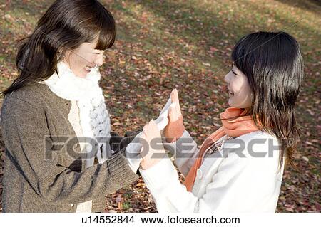 Two young women touching hands View Large Photo Image Picture - Two young women touching hands. Fotosearch