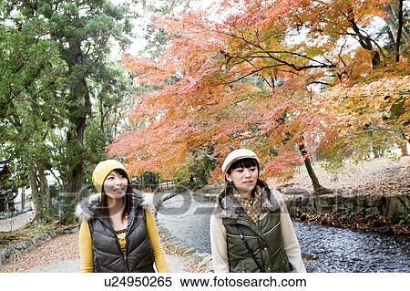 Two young women walking, Kamigamo Shrine, Kyoto Prefecture, Japan View Large Photo Image Stock Photography - Two young women walking, Kamigamo Shrine, Kyoto Prefecture, Japan. Fotosearch