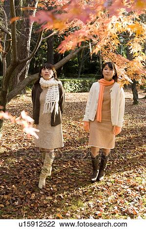Stock Image - Two young women walking. Fotosearch