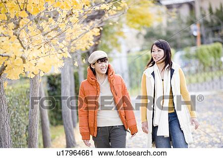 Stock Image - Two young women walking. Fotosearch