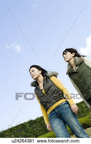 Stock Image - Two young women walking. Fotosearch
