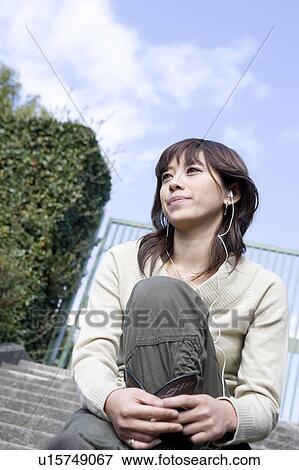 Young woman wearing earphones View Large Photo Image Stock Photo - Young woman wearing earphones. Fotosearch