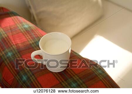 Cup of milk on sofa View Large Photo Image Stock Photo - Cup of milk on sofa. Fotosearch