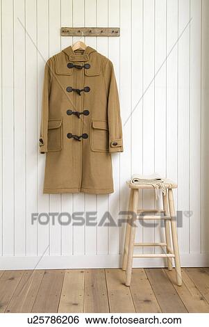 Stock Photograph - Duffel coat hanging on wall. Fotosearch