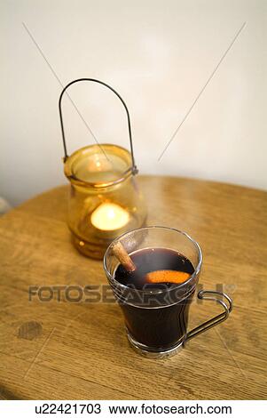 Stock Image - Glass of mulled wine and lantern. Fotosearch