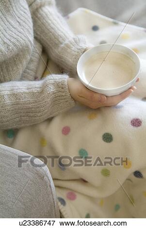 Stock Photo - Woman sitting with café au lait bowl. Fotosearch