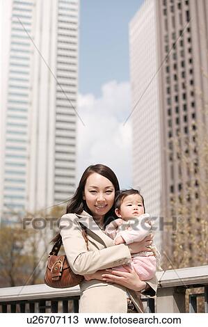 Businesswoman holding baby View Large Photo Image Stock Image - Businesswoman holding baby. Fotosearch