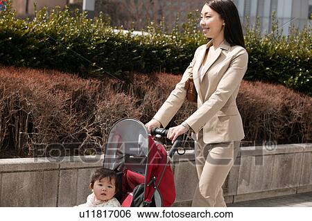 Businesswoman pushing baby stroller View Large Photo Image Stock Photograph - Businesswoman pushing baby stroller. Fotosearch