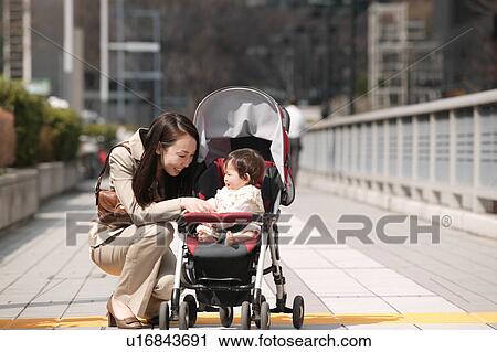 Businesswoman talking to baby View Large Photo Image Stock Image - Businesswoman talking to baby. Fotosearch