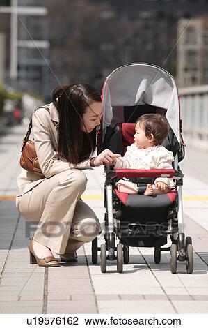 Businesswoman talking to baby View Large Photo Image Stock Image - Businesswoman talking to baby. Fotosearch