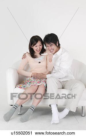 Couple looking at pregnancy test View Large Photo Image Stock Image - Couple looking at pregnancy test. Fotosearch