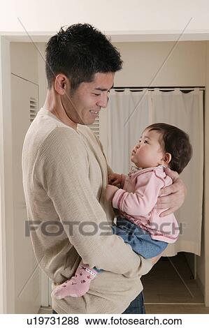 Father carrying baby View Large Photo Image Stock Photo - Father carrying baby. Fotosearch
