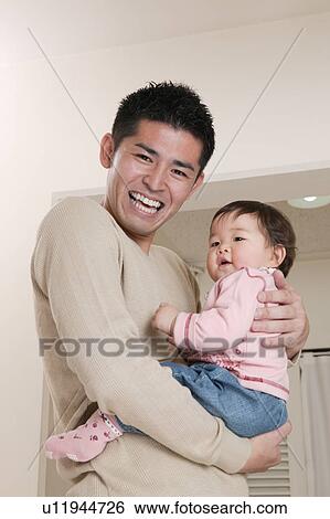 Father carrying baby View Large Photo Image Stock Photograph - Father carrying baby. Fotosearch